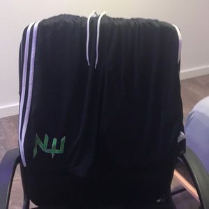 black adidas athletic shorts with green NW print